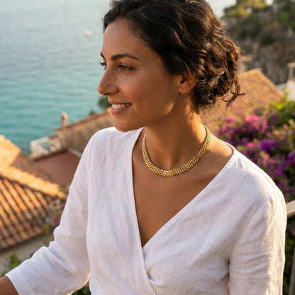 Mesh chain necklace gold profile subtle smile Amalfi coast sunset