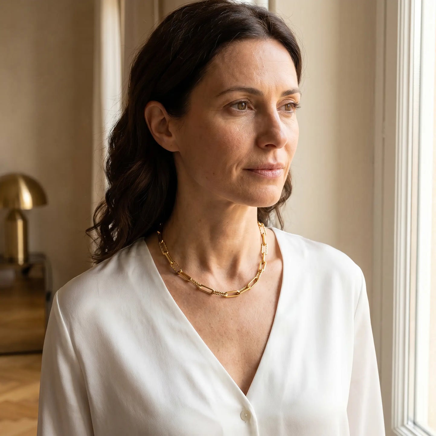 Mixed paperclip necklace gold worn 3/4 portrait — white silk shirt, Italian villa morning light