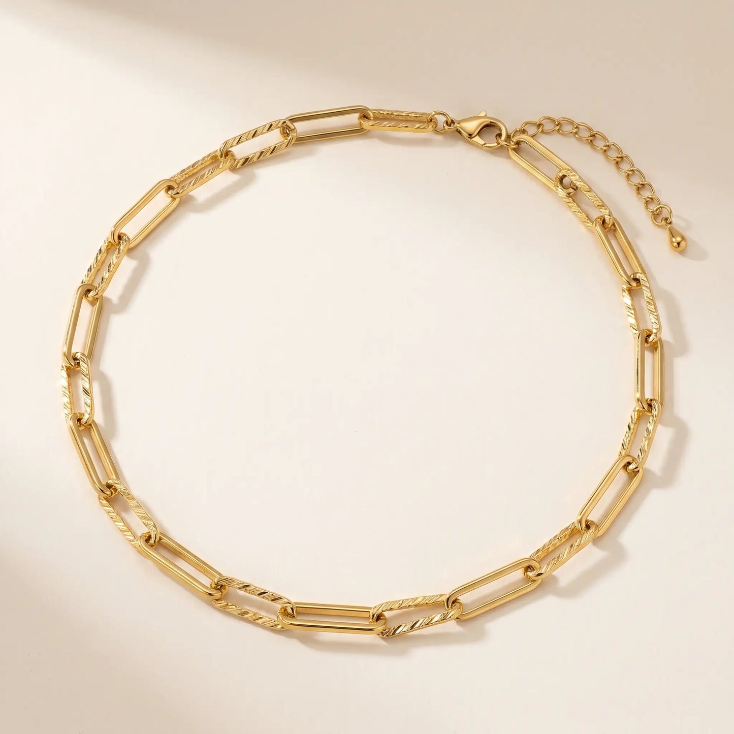Mixed paperclip necklace gold packshot — alternating textured and smooth rectangular links 7.5mm wide