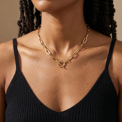 Paperclip toggle necklace gold worn close-up at collarbone with T-bar clasp