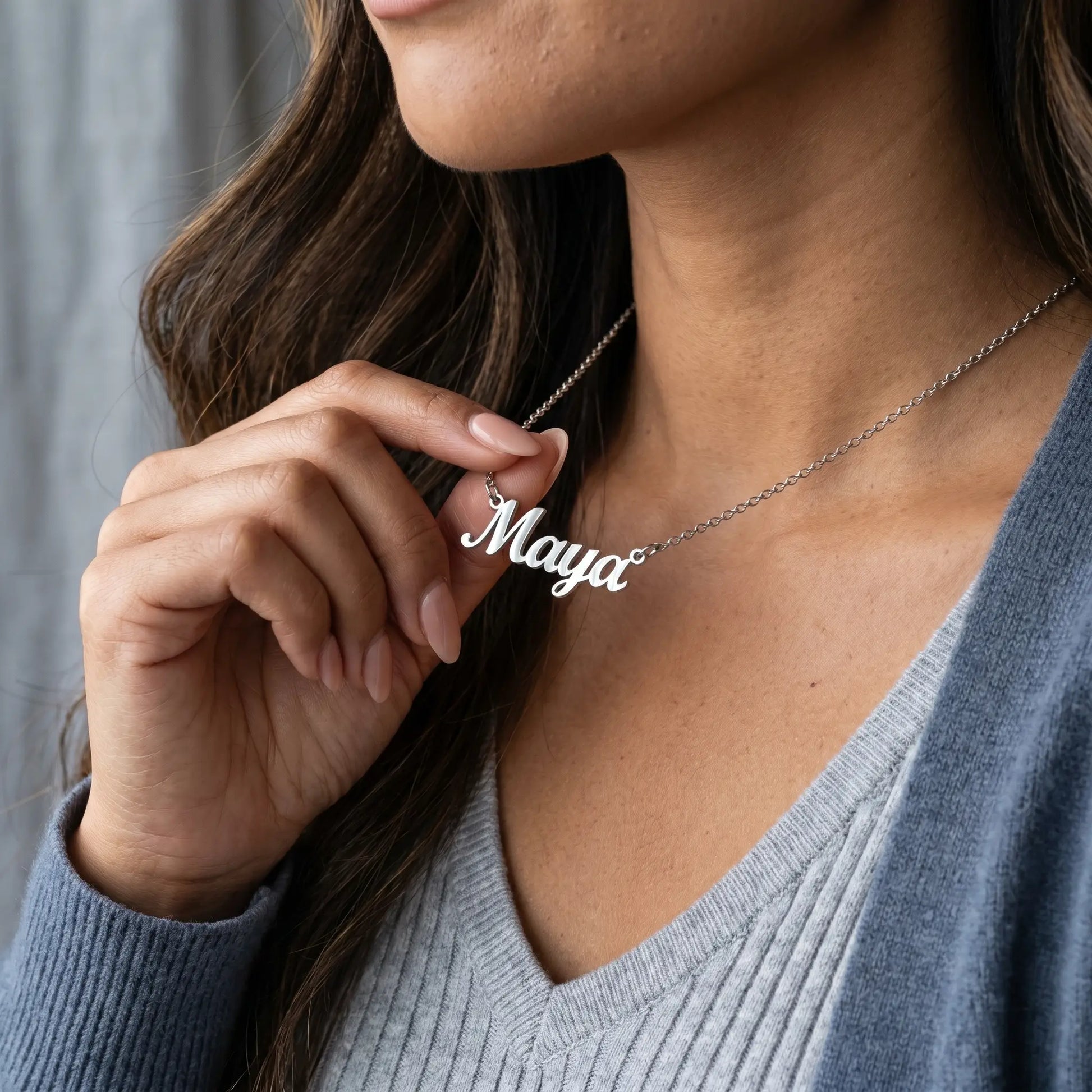 Close-up of a woman wearing a Personalised Plate Chain in 18K Gold by AUREATE with the name Maya engraved.