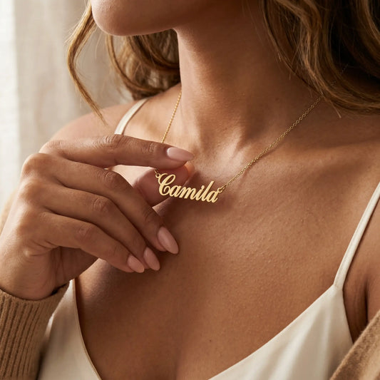 Personalised Plate Chain in 18K Gold by AUREATE, shown on model with custom name Camila.