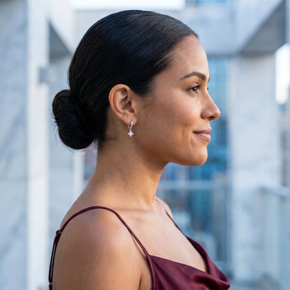 Silver petite clover huggie earrings profile editorial