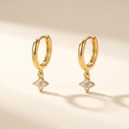 Gold petite clover huggie earrings packshot pair