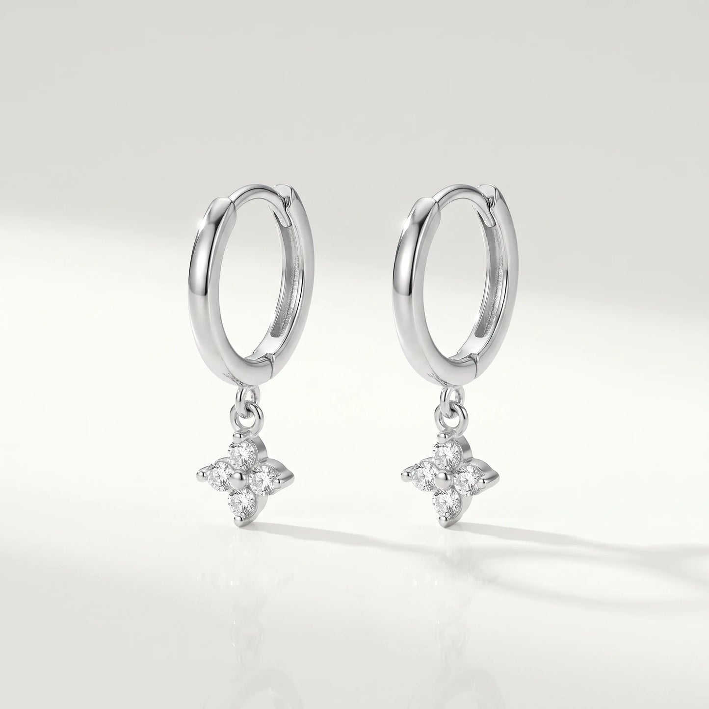 Silver petite clover huggie earrings packshot pair