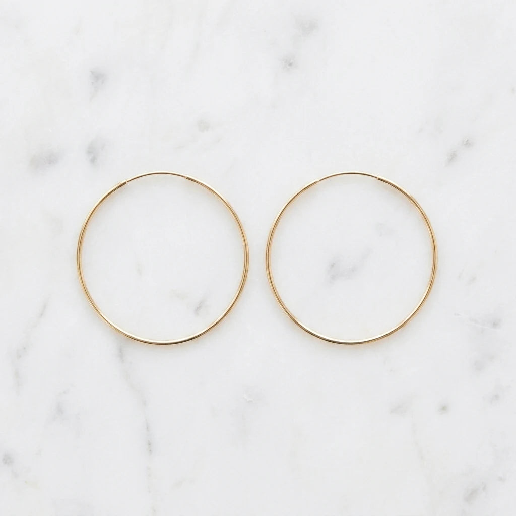 Timeless Gold Hoop Earrings flat lay pair on marble