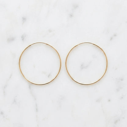 Timeless Gold Hoop Earrings flat lay pair on marble