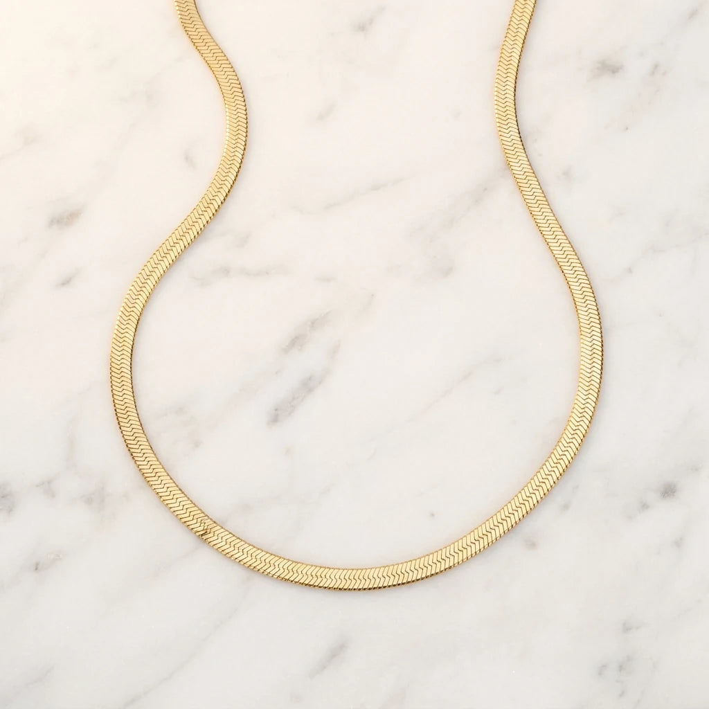 3mm Herringbone Gold Chain flat lay on marble