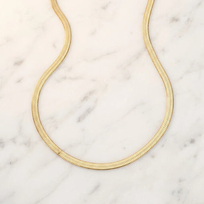 3mm Herringbone Gold Chain flat lay on marble