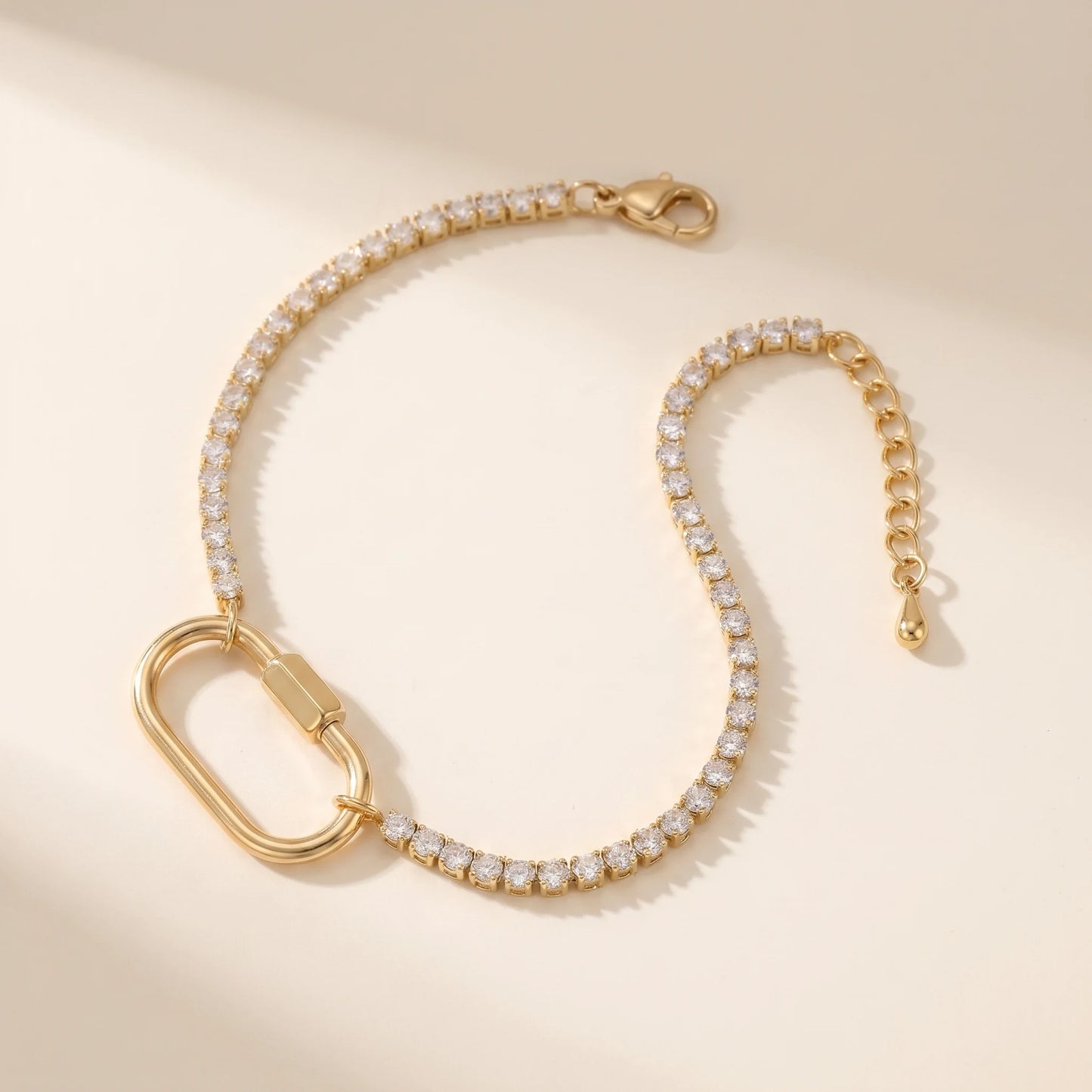 Gold tennis bracelet with oval carabiner lock pendant - packshot 18K gold CZ pave stainless steel with 3cm cable extender