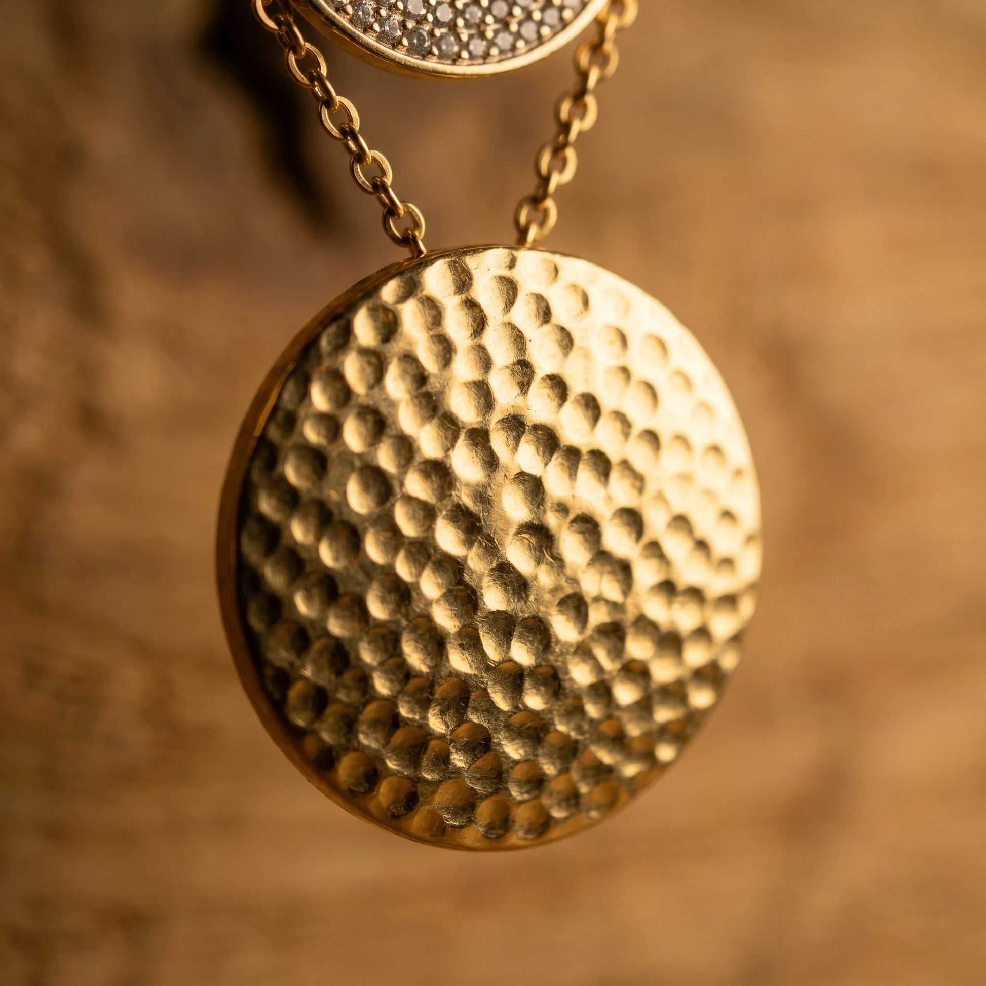 Hammered gold coin disc macro detail texture craftsmanship