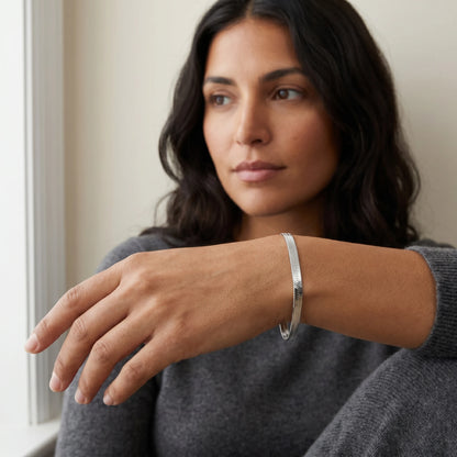 Silver herringbone bracelet worn close-up