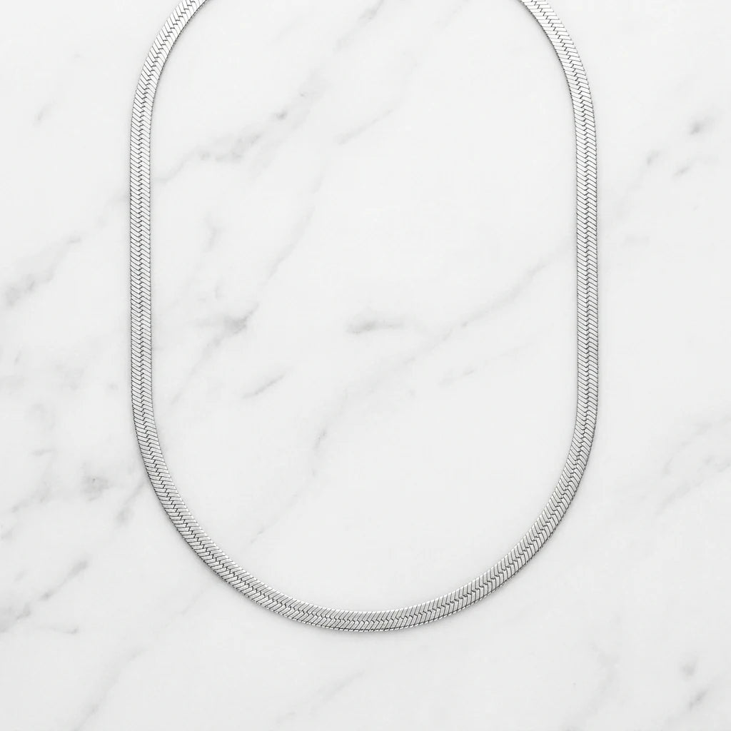 3mm Herringbone Silver Chain flat lay on marble