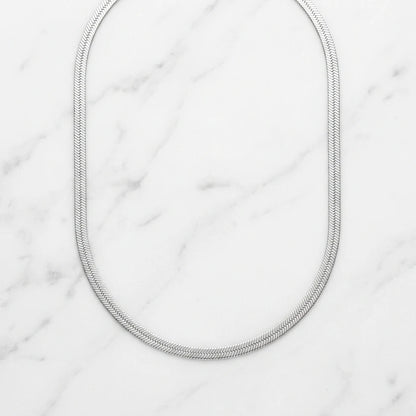 3mm Herringbone Silver Chain flat lay on marble