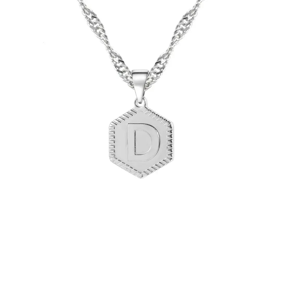 Hexagon Initial Necklace by AUREATE featuring a silver hexagon pendant with letter D on wave chain.