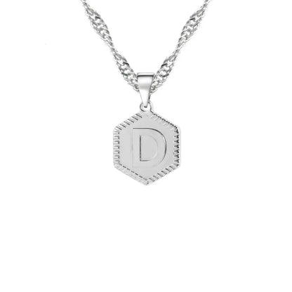 Hexagon Initial Necklace by AUREATE featuring a silver hexagon pendant with letter D on wave chain.