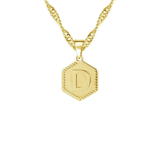 Hexagon Initial Necklace by AUREATE featuring a gold pendant with initial 'D' on a wave chain.