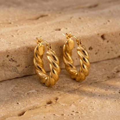 Twisted Gold Hoop Earrings pair - packshot on travertine