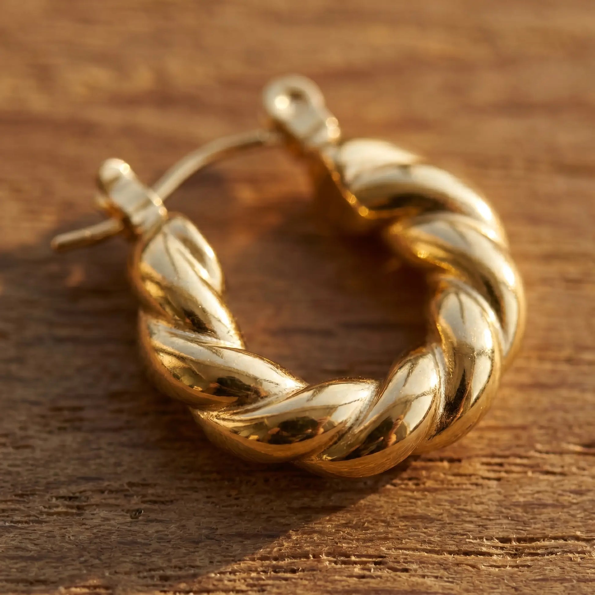 Twisted Gold Hoop Earring - extreme macro twisted texture on oak
