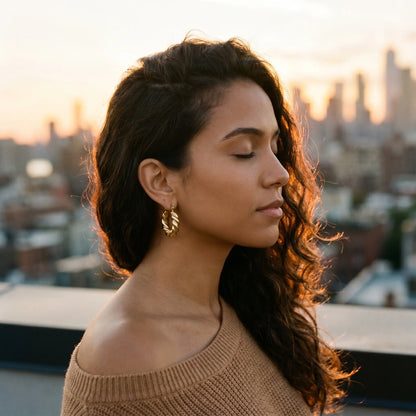 Woman on rooftop wearing Twisted Gold Hoop Earrings - sunset lifestyle