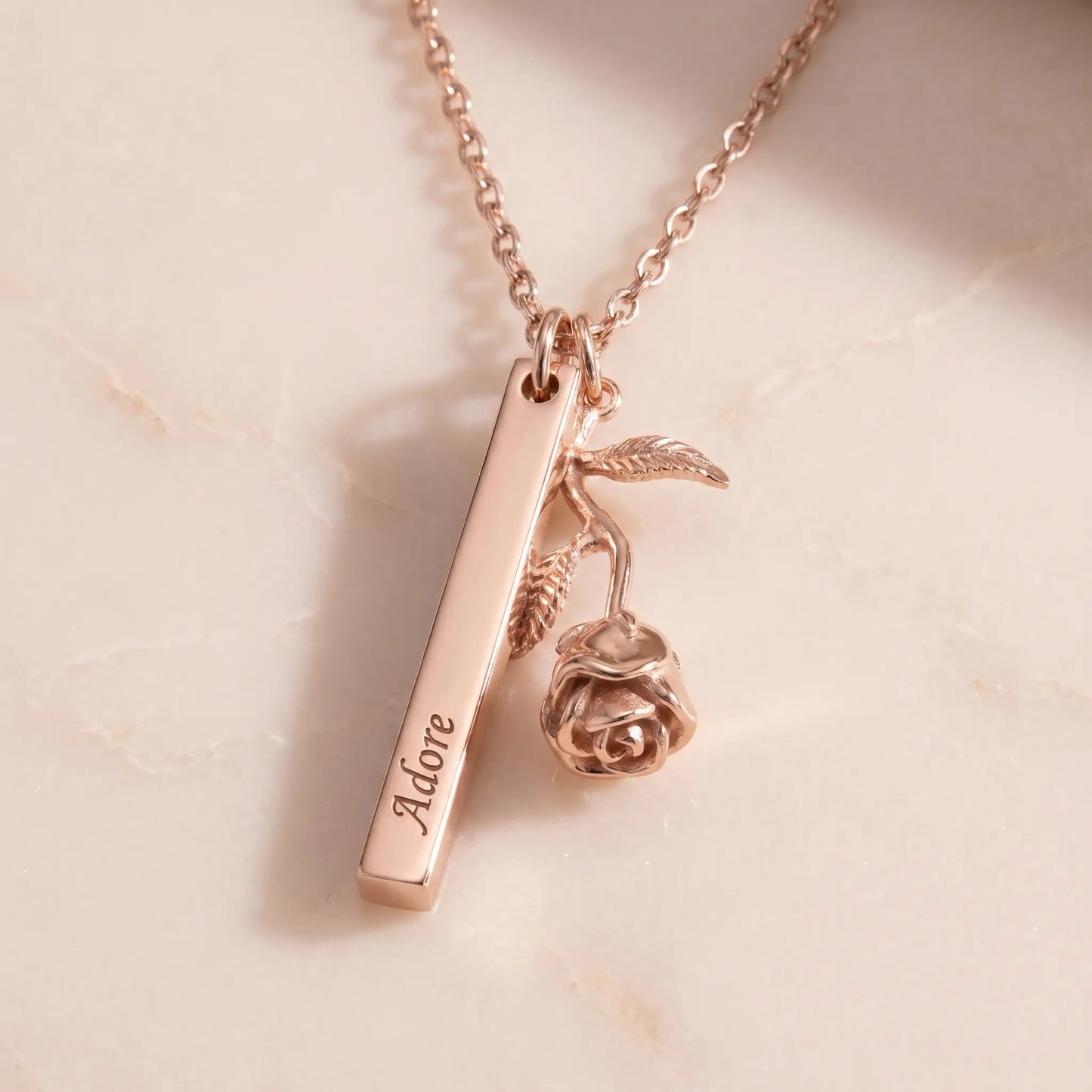 Rose Gold Engraved Bar Pendant in rose gold packshot with rose flower charm Adore engraving