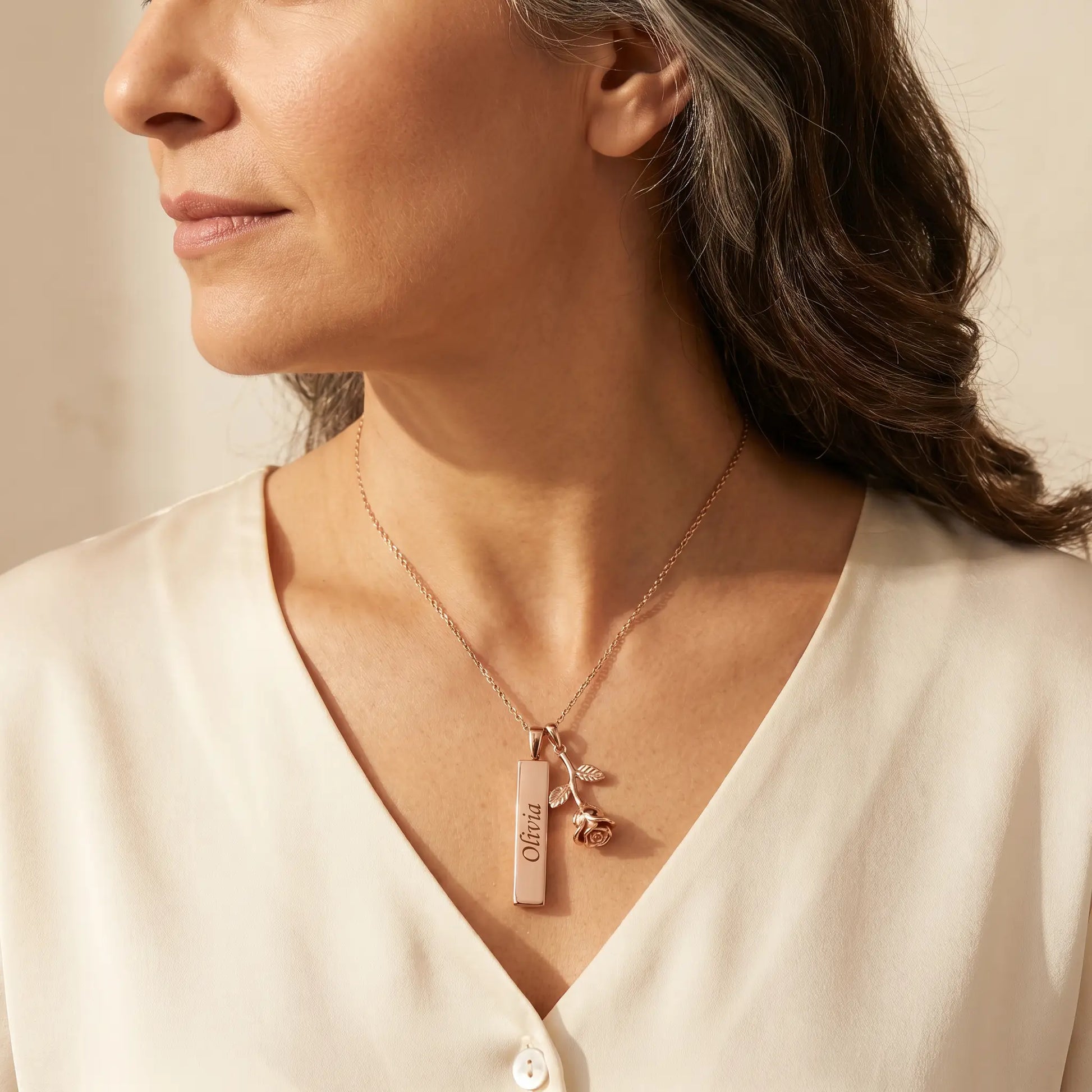 Rose Gold Engraved Bar Pendant in rose gold worn by mature woman three quarter profile Olivia engraving