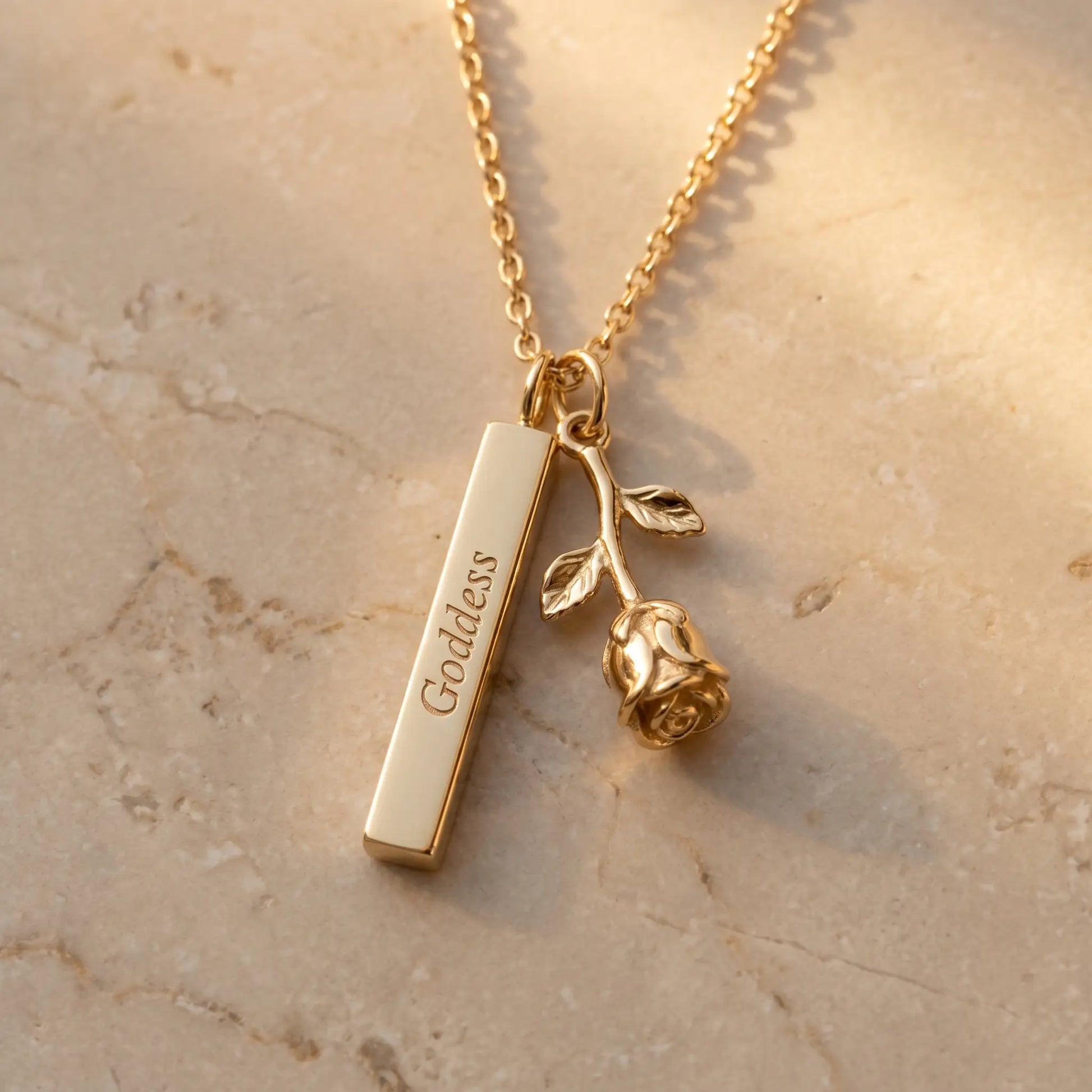 Rose Gold Engraved Bar Pendant in 18K gold packshot with rose flower charm and Goddess engraving