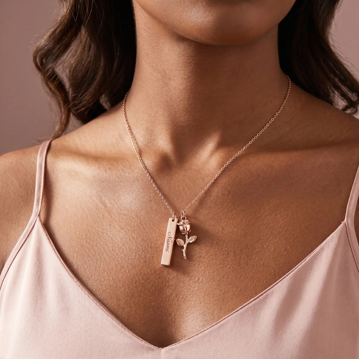 Rose Gold Engraved Bar Pendant in rose gold worn by woman with engraved name Naomi at collarbone