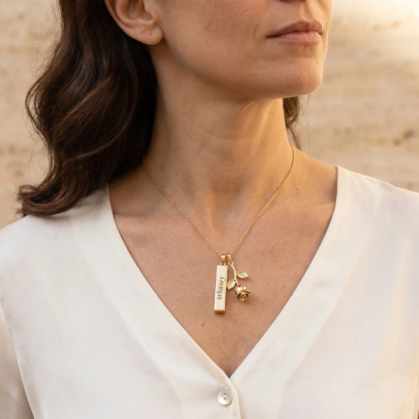 Rose Gold Engraved Bar Pendant in 18K gold worn by mature woman with engraved name Whitney three quarter profile