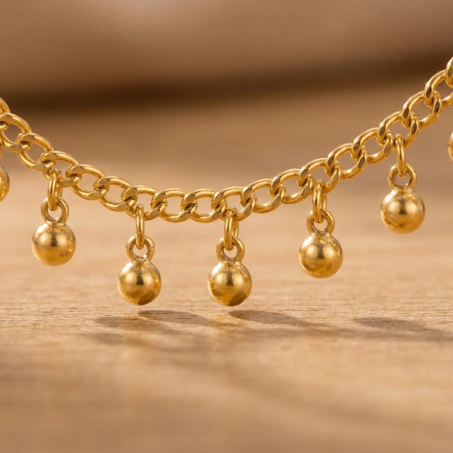 Gold drop bead anklet macro detail - tiny gold ball drops hanging from chain links