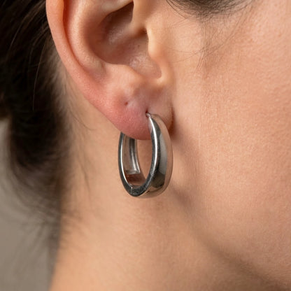 Silver tone stainless steel chunky dome hoop earrings, macro detail on the earlobe | SKU: AUR-CHKDOM-S