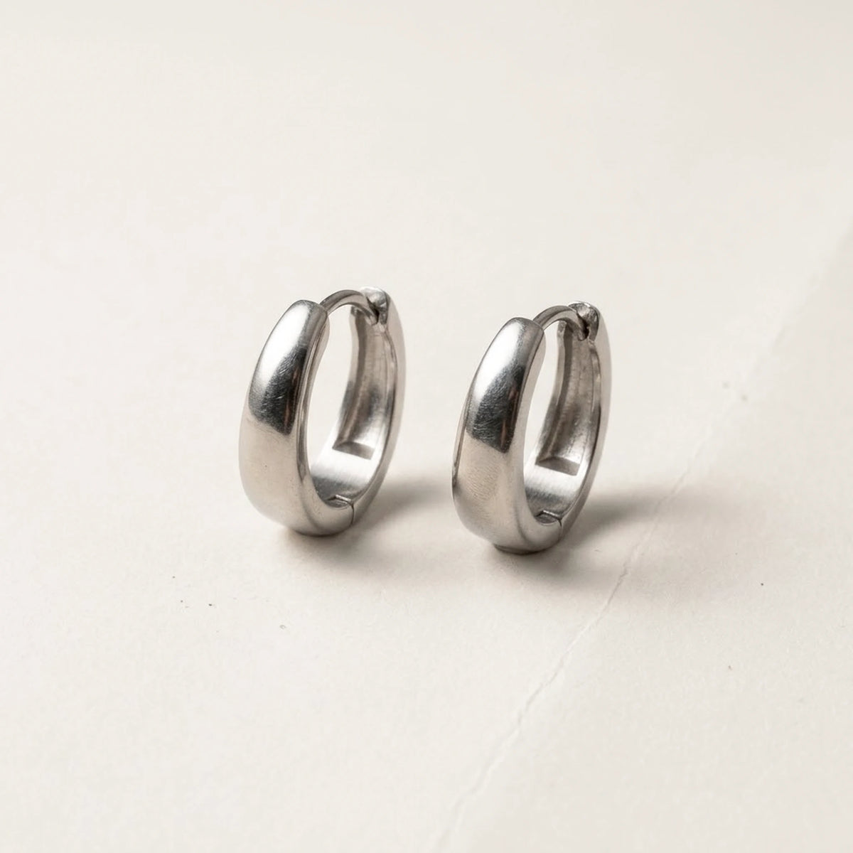 Silver tone stainless steel chunky dome hoop earrings, product shot on white | SKU: AUR-CHKDOM-S