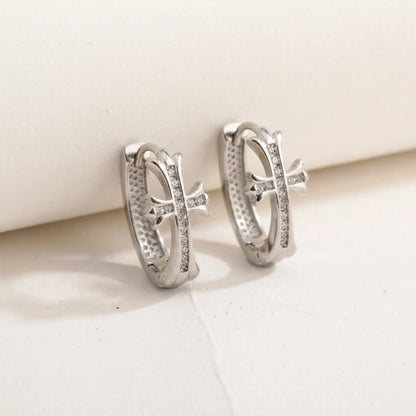 Silver tone stainless steel pave cross huggie hoop earrings, product shot on white | SKU: AUR-CRXHUG-S