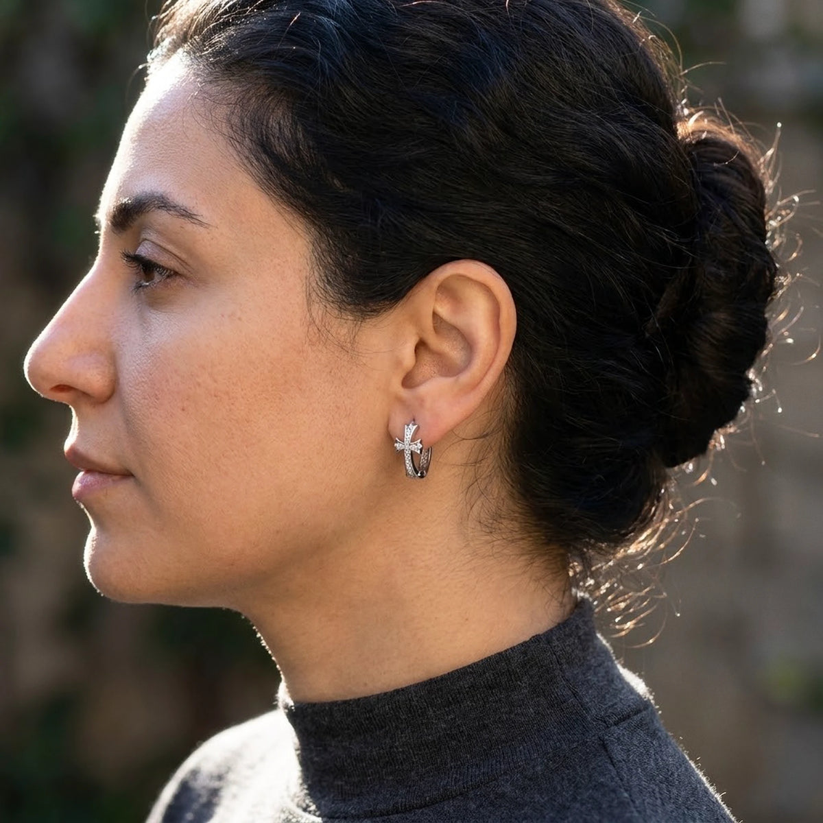 Silver tone stainless steel pave cross huggie hoop earrings, worn, side profile | SKU: AUR-CRXHUG-S