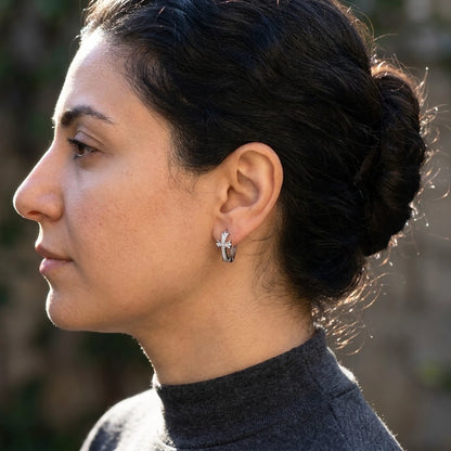 Silver tone stainless steel pave cross huggie hoop earrings, worn, side profile | SKU: AUR-CRXHUG-S