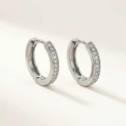 Silver tone stainless steel pave huggie hoop earrings, product shot on white | SKU: AUR-PVHUGG-S