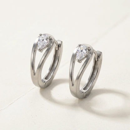Silver tone stainless steel pear cut crystal huggie hoop earrings, product shot on white | SKU: AUR-PRCZHG-S