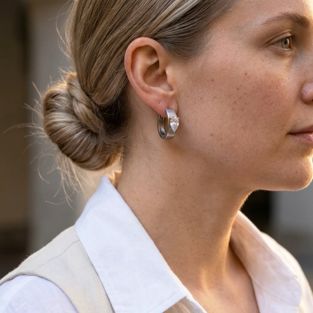 Silver tone stainless steel pear cut crystal huggie hoop earrings, worn, side profile | SKU: AUR-PRCZHG-S