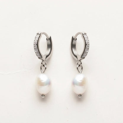 Silver tone stainless steel freshwater pearl drop huggie earrings, product shot on white | SKU: AUR-PRLHUG-S