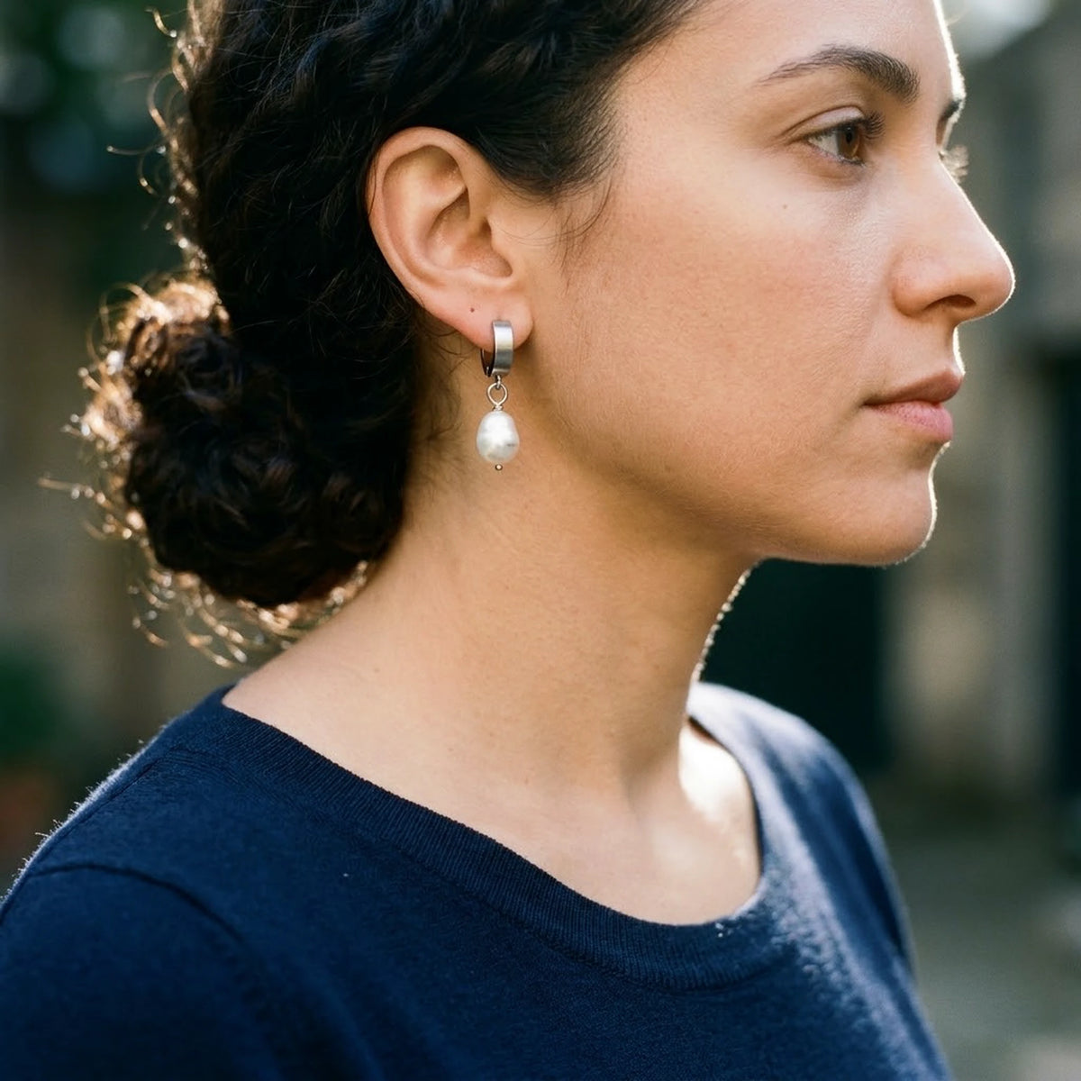 Silver tone stainless steel freshwater pearl drop huggie earrings, worn, side profile | SKU: AUR-PRLHUG-S