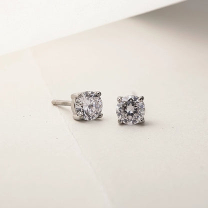 Silver tone stainless steel cubic zirconia solitaire stud earrings, product shot on white | SKU: AUR-SOLSTD-S