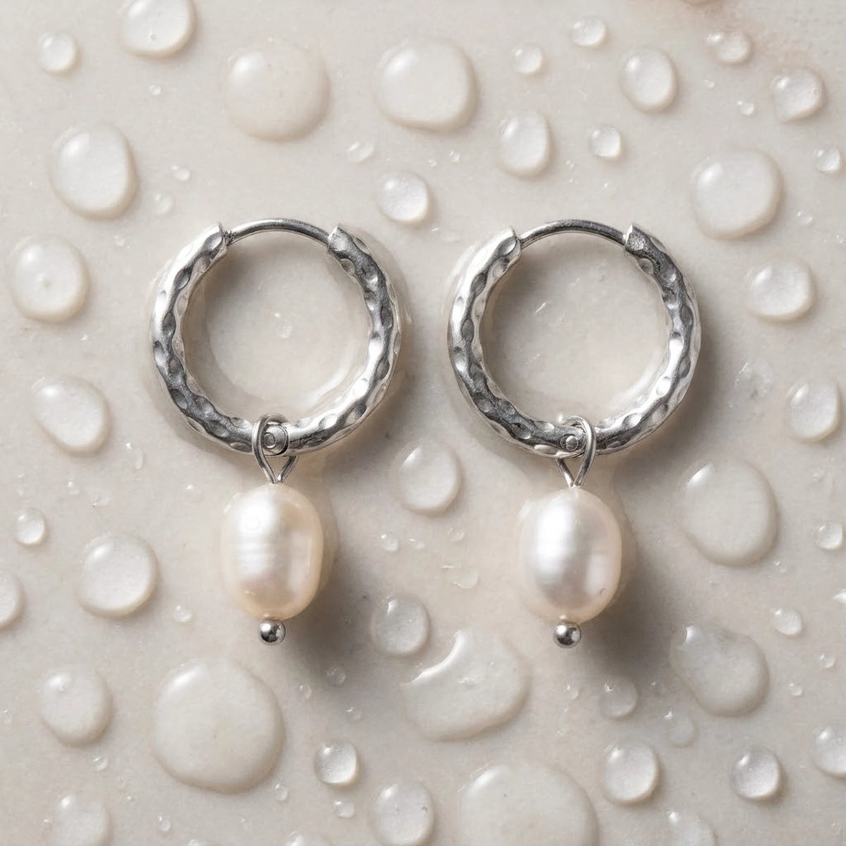 Silver tone stainless steel twisted rope pearl drop hoop earrings, still life on a wet surface, waterproof | SKU: AUR-TWPRLH-S