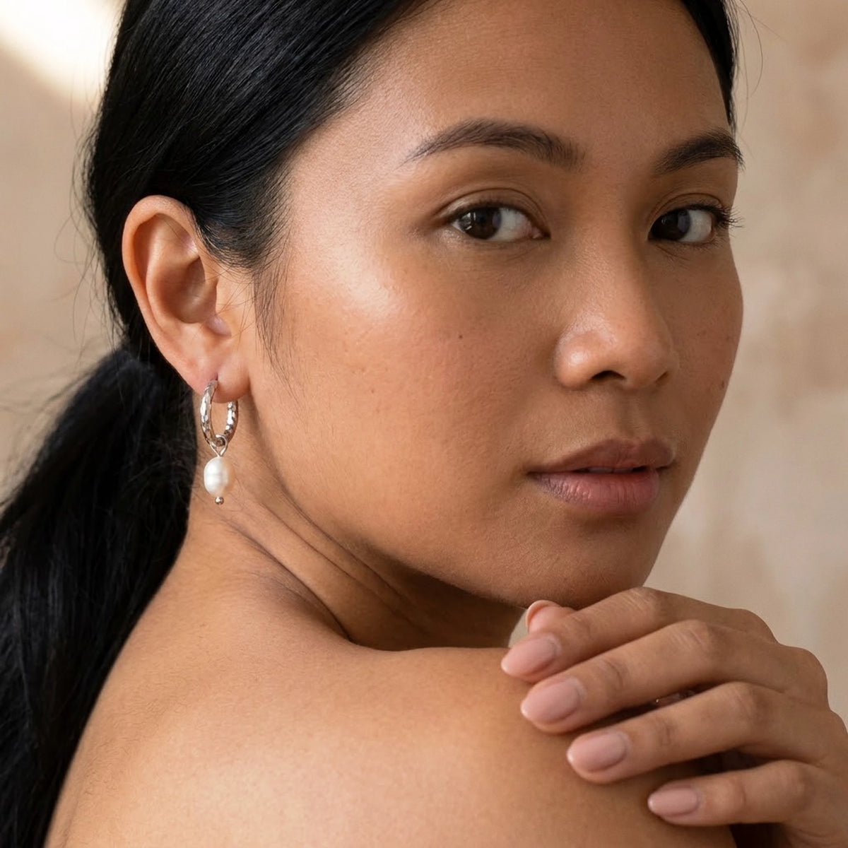 Silver tone stainless steel twisted rope pearl drop hoop earrings, worn, over the shoulder portrait | SKU: AUR-TWPRLH-S