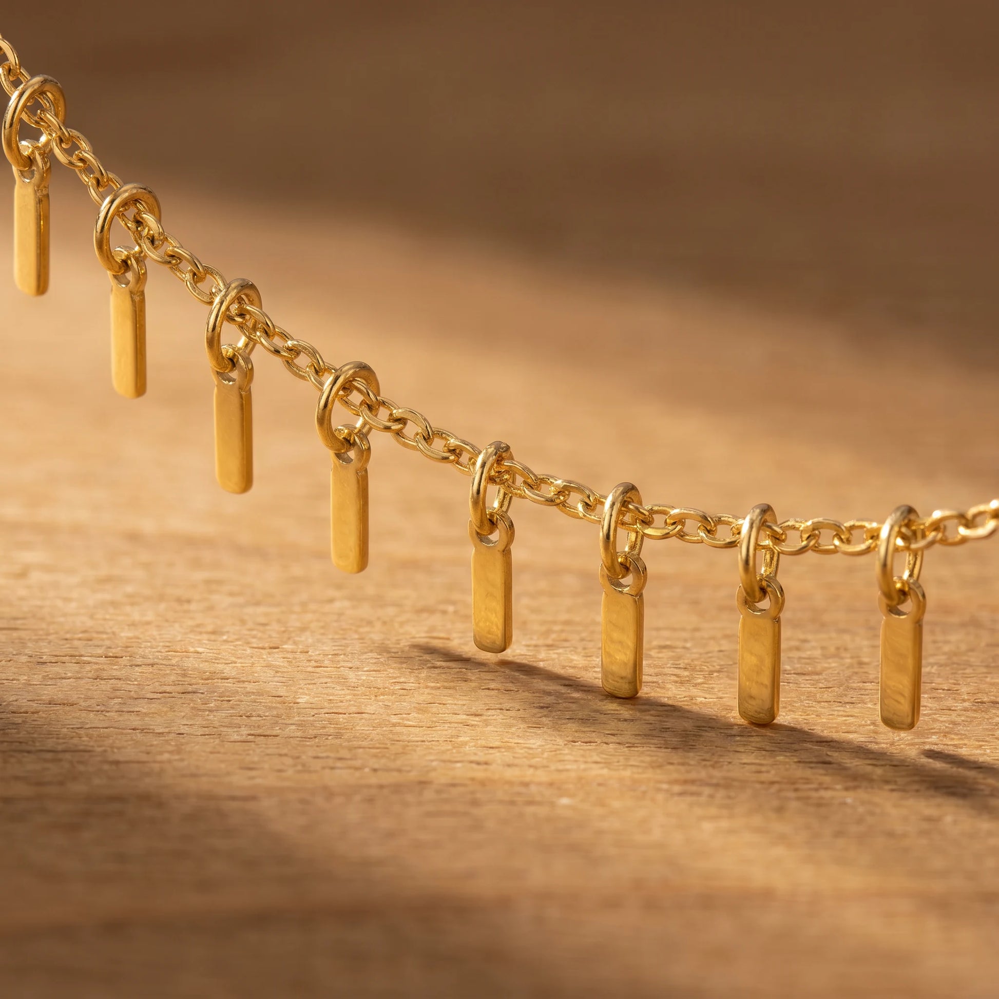 Gold Sun Ray Fringe Anklet macro detail of fringe bars