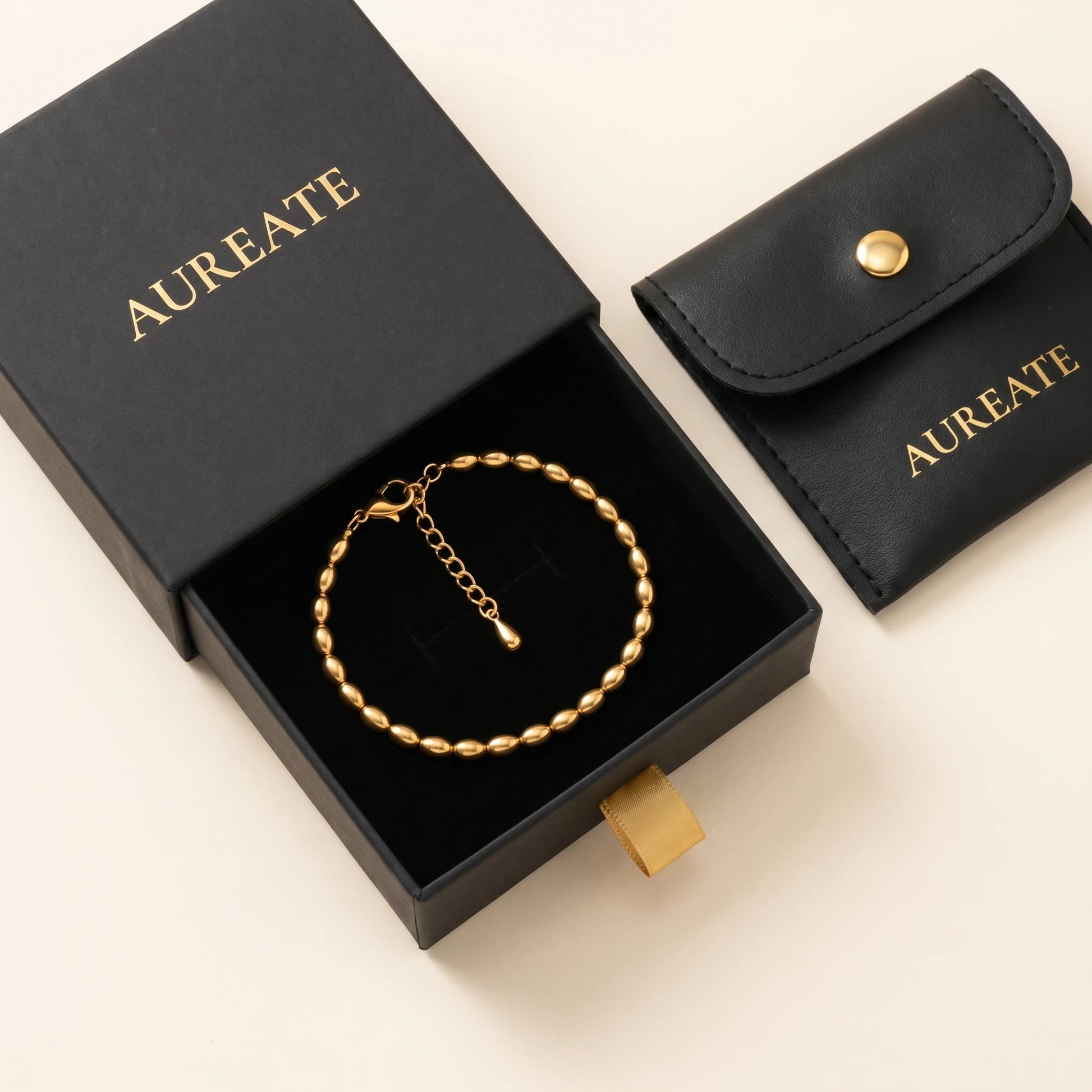 Gold oval bead anklet in AUREATE gift box with leather pouch