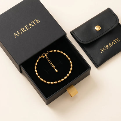 Gold oval bead anklet in AUREATE gift box with leather pouch
