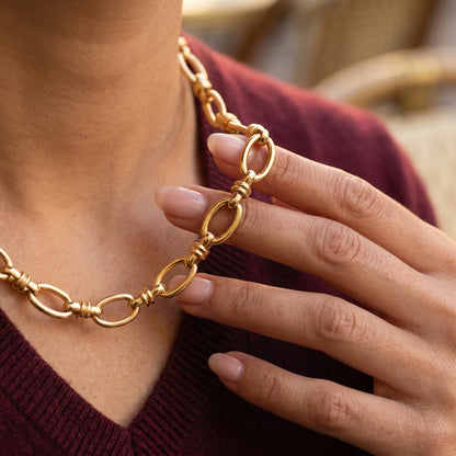 Vintage rolo necklace gold hand-to-jewelry intimate close-up Paris cafe