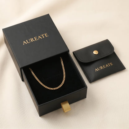 18k gold 4mm curb-link anklet displayed inside open AUREATE gift box, gold logo